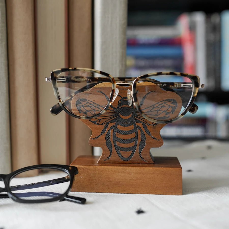 Bee Eyeglass Holder is wooden with a black bee design on the front