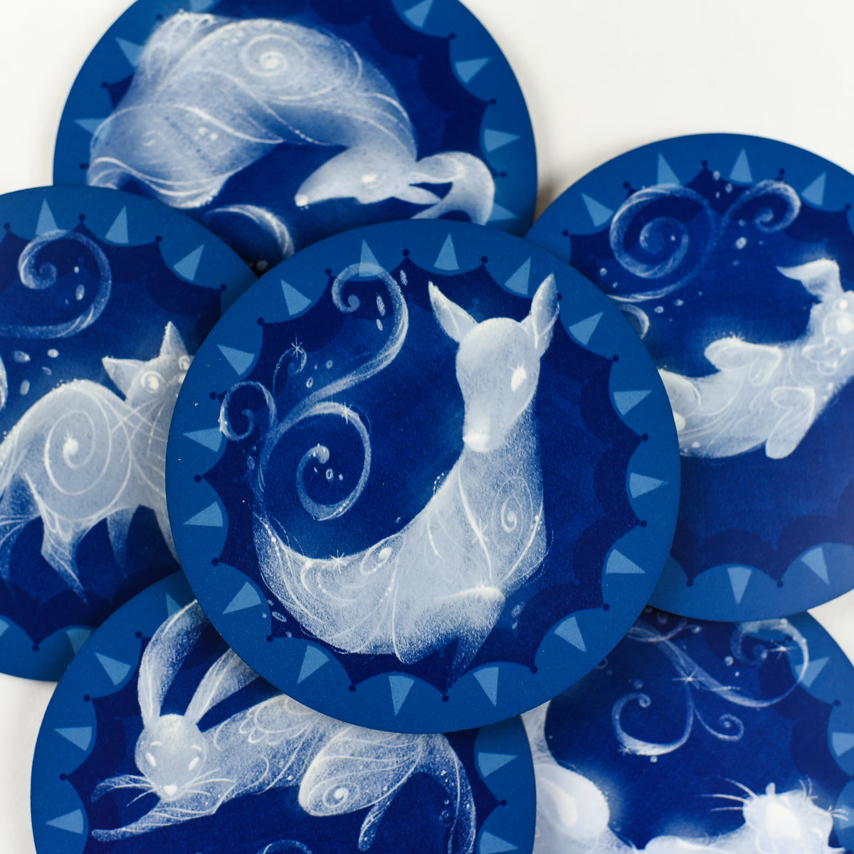 Set of 6 round blue and white Magical Animal Familiar Coasters includes an otter, stag, hare, doe, terrier, and cat.