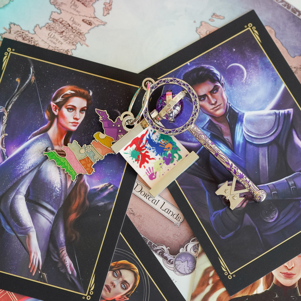 ACOTAR Collectible Key with a glitter bubble, tattoos on the key shaft, a Prythian Courts Charm, and a Canvas Charm