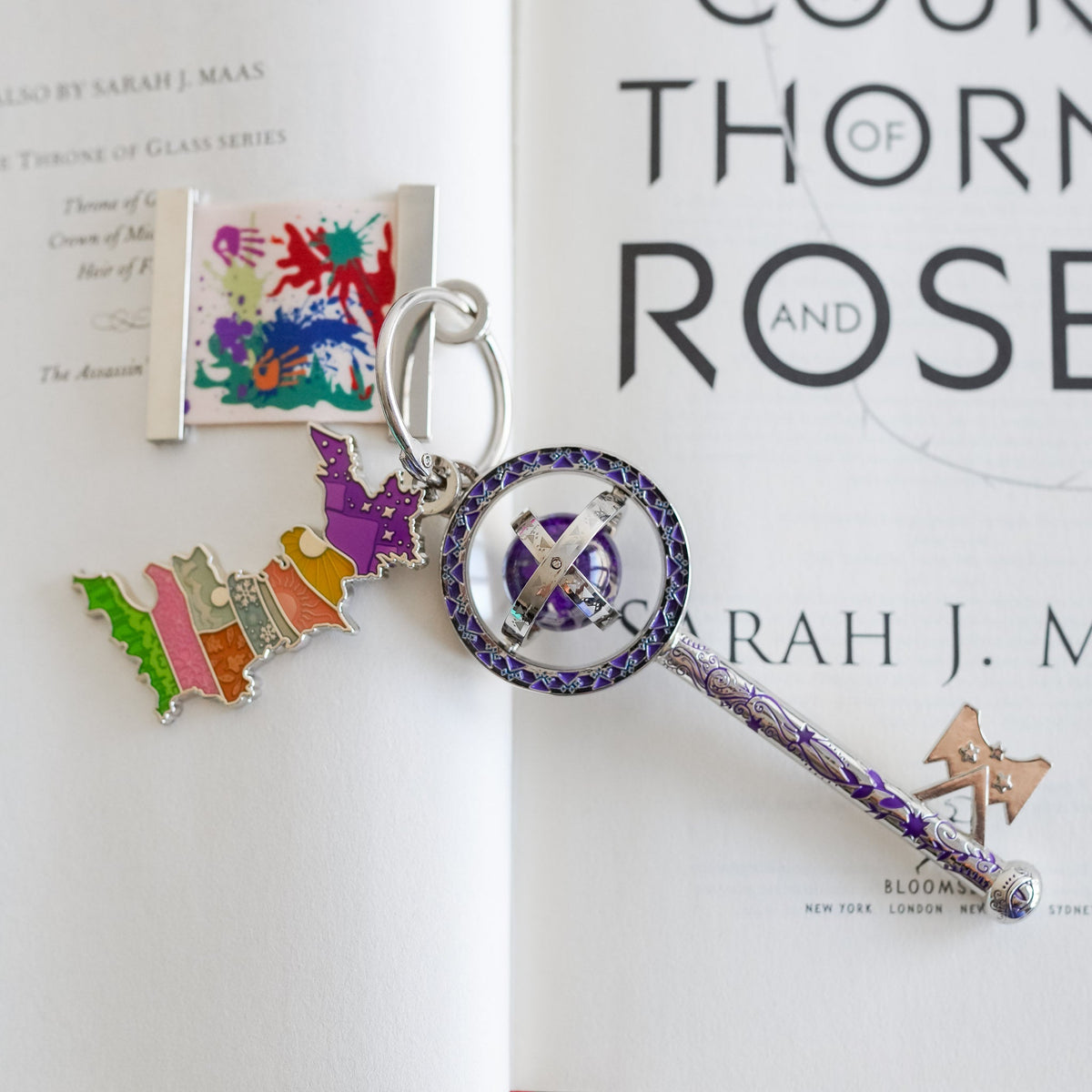 ACOTAR Collectible Key with a glitter bubble, tattoos on the key shaft, a Prythian Courts Charm, and a Canvas Charm