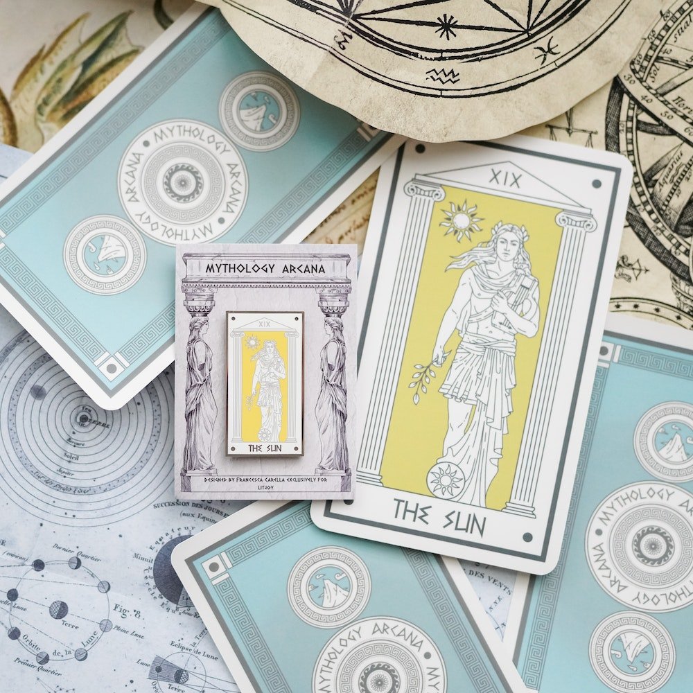 Apollo The Sun, Mythology Tarot Enamel Pin appears before a sunlit yellow background with lyre and laurel in hand