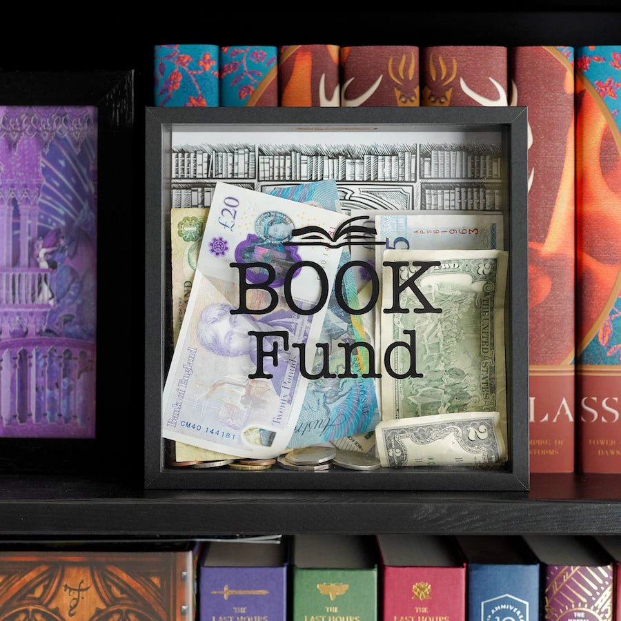 A square shadow box with with an opening on top, "Book Fund" on front panel, and a sketched library backdrop. 