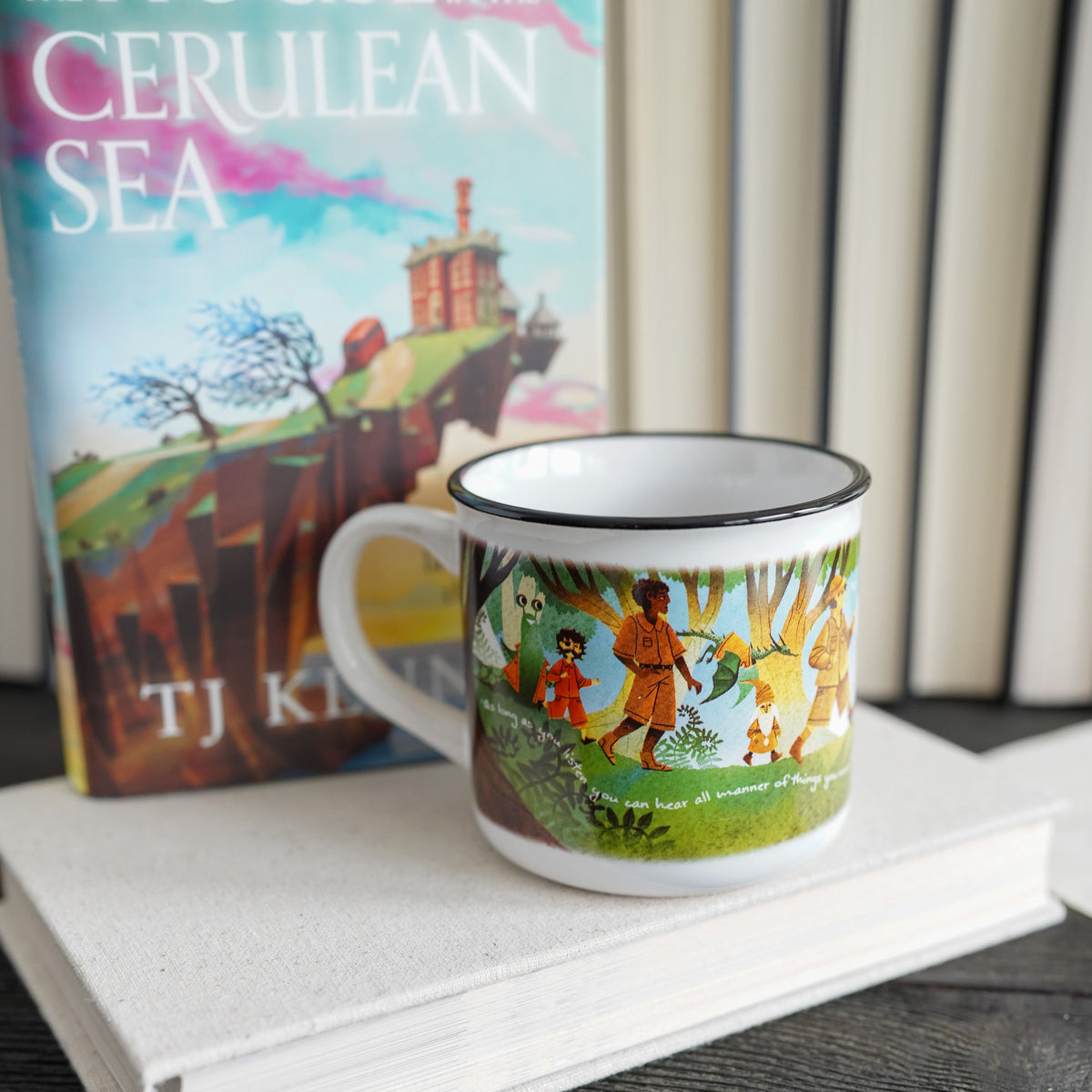 Cerulean Sea Mug has characters from T.J. Klune&#39;s book hiking on a grassy hill with the sea in background.