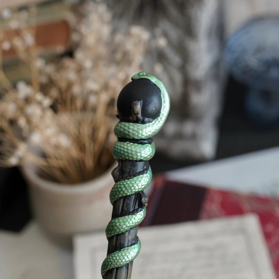 This Green Snake Wand is a black wand with green serpent twirling around the top half of the core.