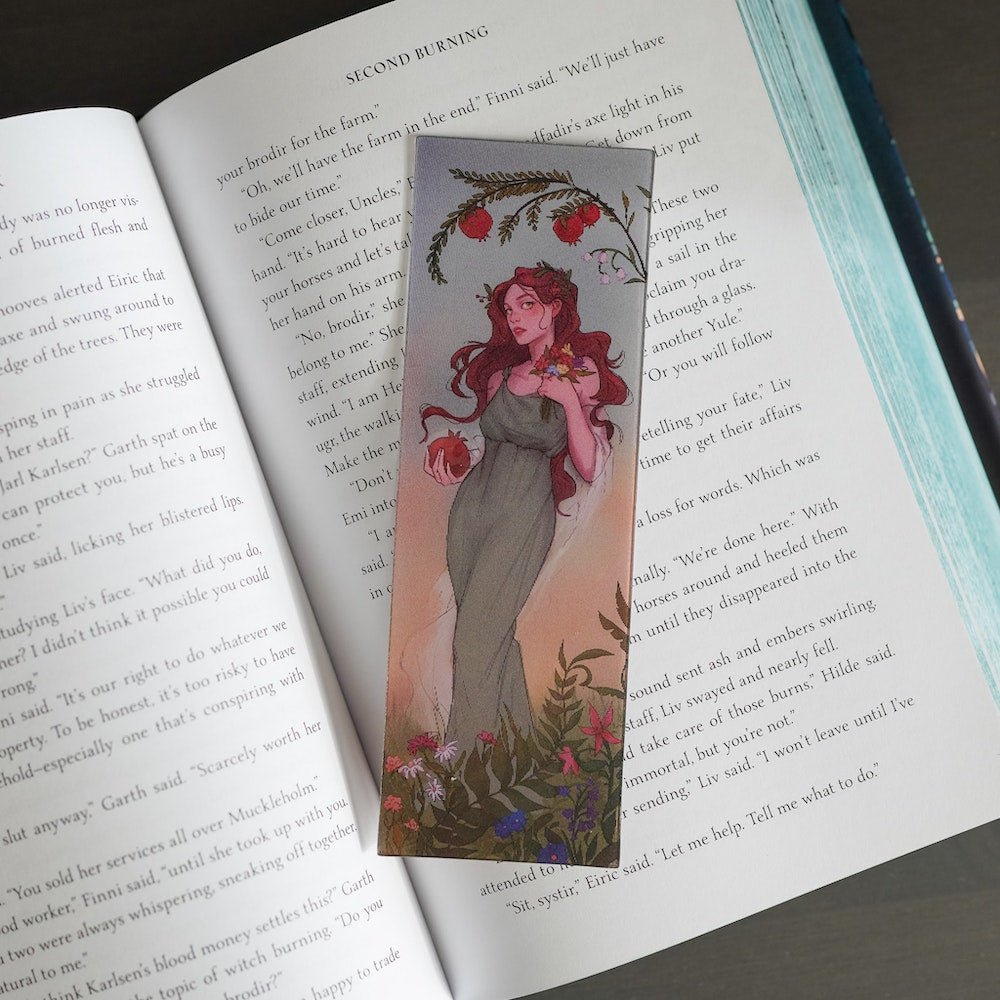 Persephone Lenticular Bookmark displays Persephone in spring flowers and transitions to her as Queen of the Underworld holding a skull