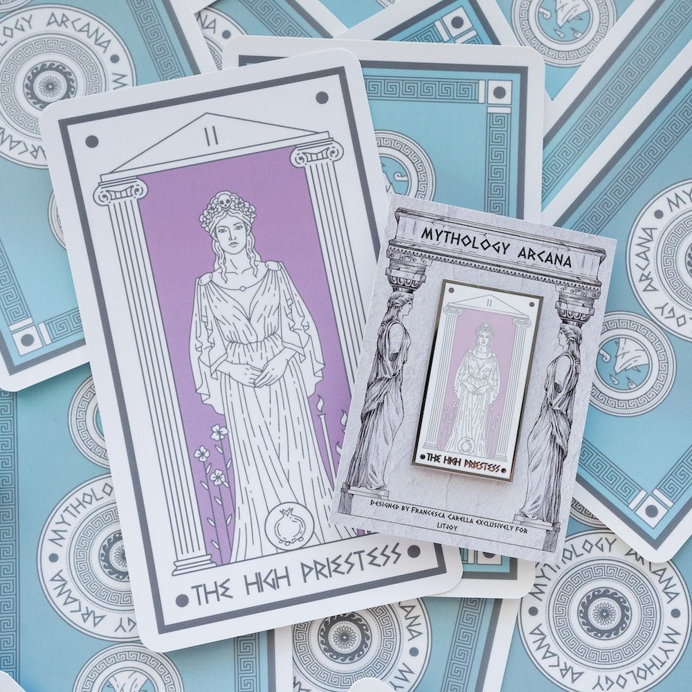 Persephone The High Priestess, Mythology Tarot Enamel Pin stands between flowers and torches on a lilac background.