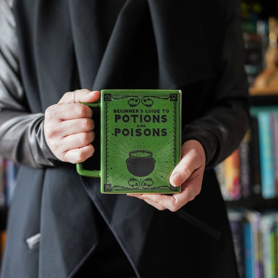 Beginner's Guide to Potions and Poisons Book Mug with a bubbling cauldron