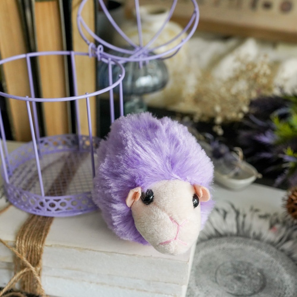 Magical purple Puff Pet next to a Cage