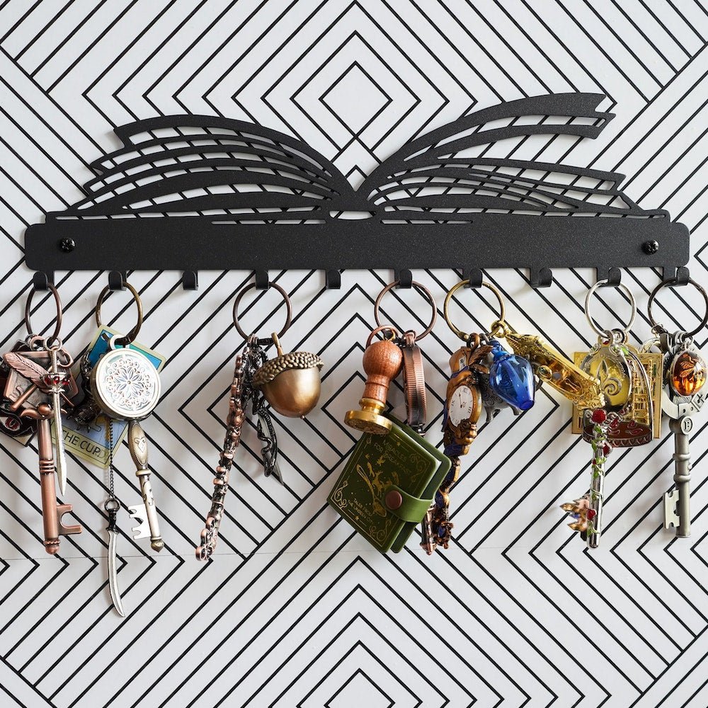 Storybook Key Rack with ten hooks beneath a metal recreation of an open book
