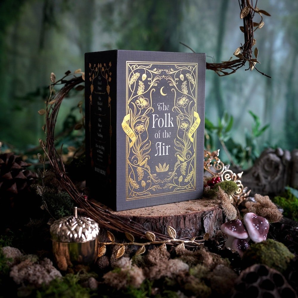 The Folk of the Air Box Set from LitJoy Crate is dark brown with gold foiling of leaves and flowers. It&#39;s surrounded by a woodland theme.