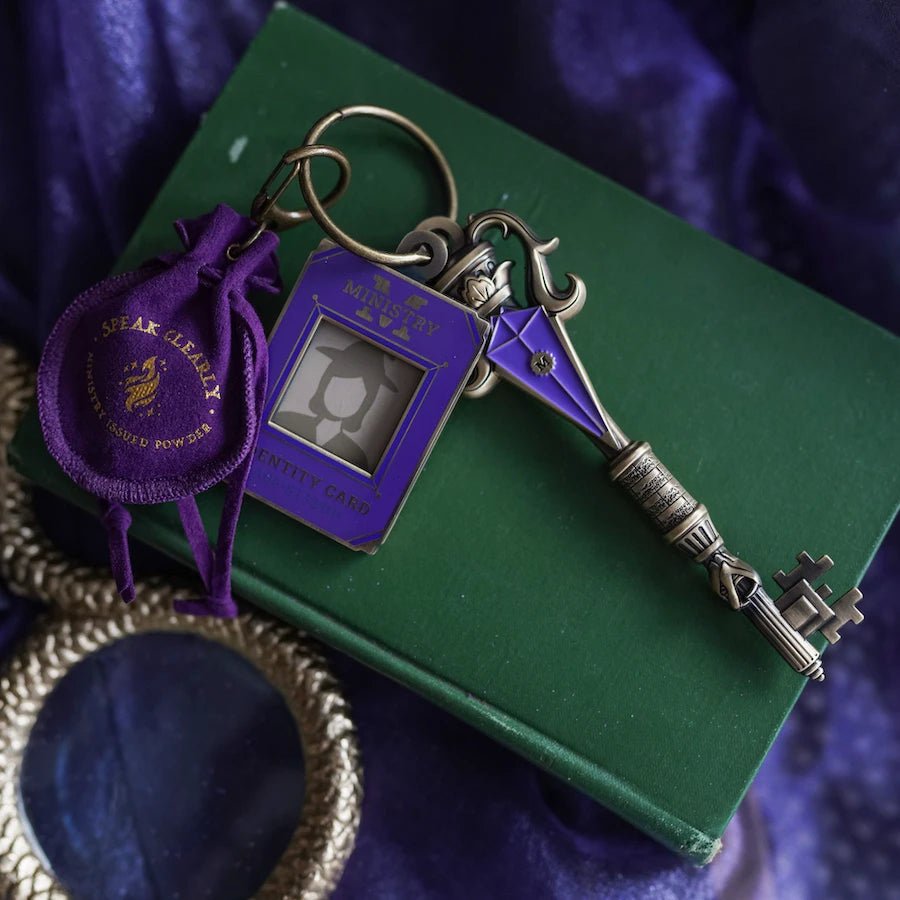 Silver & purple metal Wizard Government Key with engraved "M." Comes with Ministry Identity Card charm and purple pouch with the words "Speak clearly. Ministry issued powder."