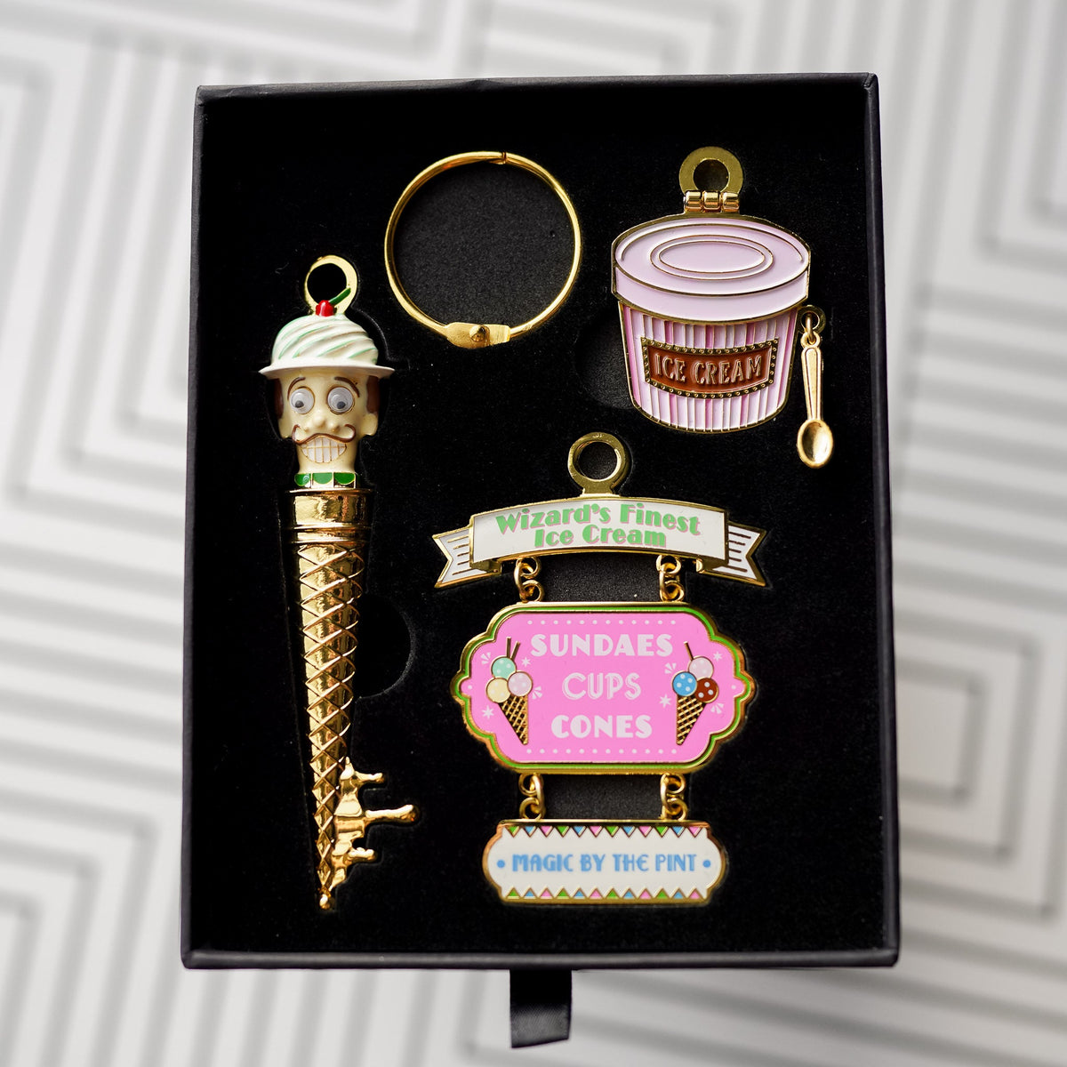 Wizard Ice Cream Shoppe Key with a mustached face, an ice cream bucket charm, and a hanging sign charm.