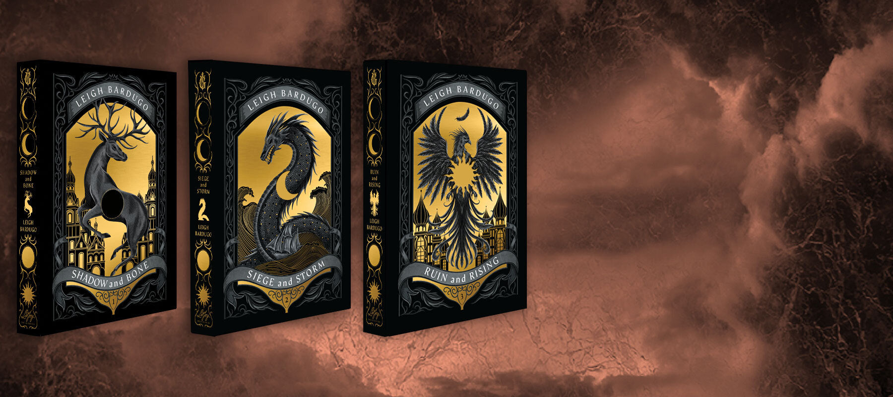LitJoy's Edition of Shadow and Bone by Leigh Barduo, featuring gold foiled cover dust jackets of the stag, sea whip, and firebird amplifiers with die cuts of eclipse, crescent moon, and sun