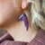 ACOTAR Bat Boy Wings Earrings are sparkly, purple earrings shaped like bat wings from the Sarah J. Maas Collection.