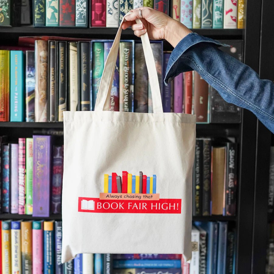 Book Fair Tote Bag is a canvas tote bag with "Always chasing the book fair high!" and a shelf of books printed on the front.