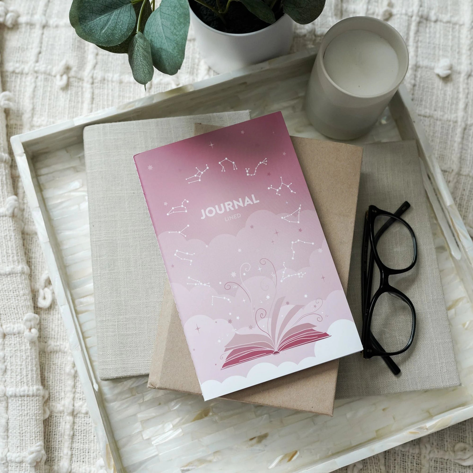 Build Your Own Planner: Lined Notebook is a dark pink lined journal with 70 blank lined pages and an astrology themed cover.