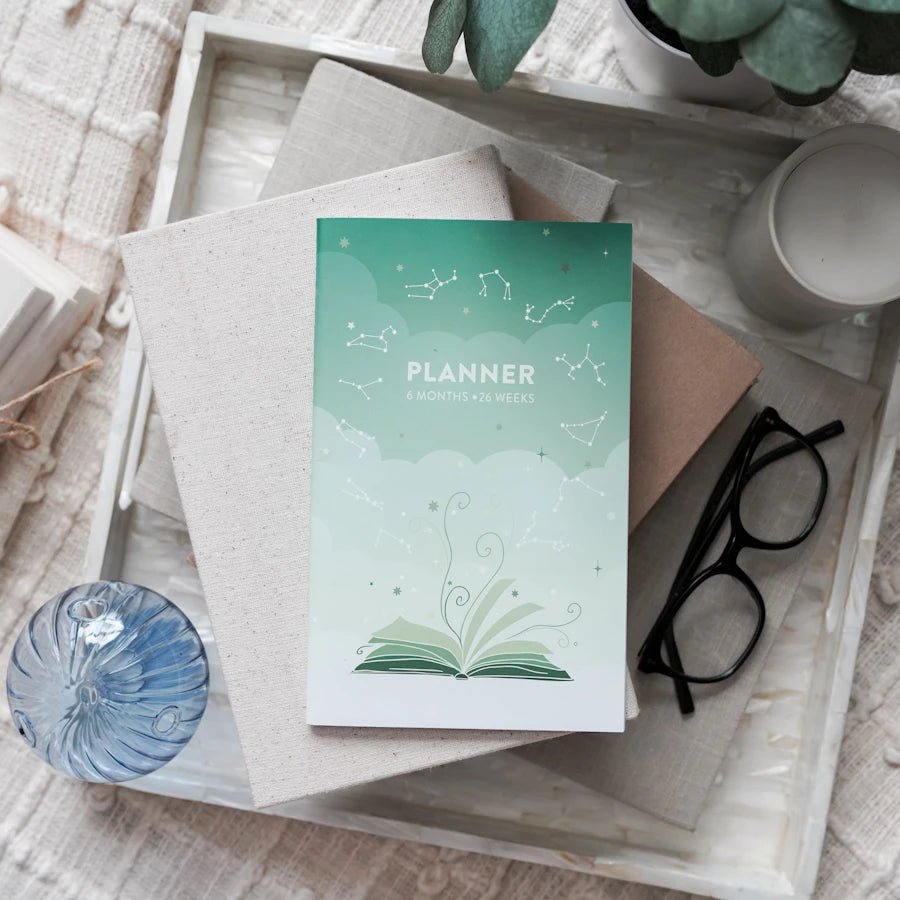 Build Your Own Planner: Six Month Planner—green ombre mini planner with open book, clouds, and zodiac constellations on cover