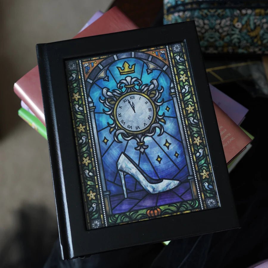 Cinderella Fairytale Notebook with a glass slipper and clock ticking to midnight in stained glass art on the cover