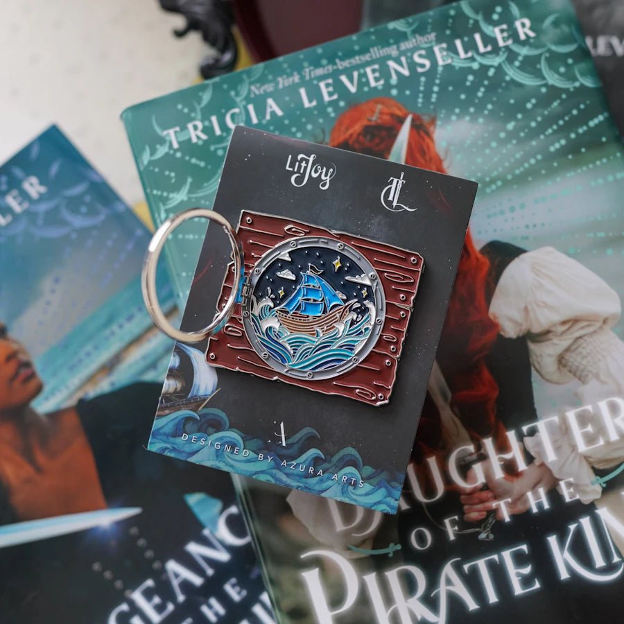 Our Daughter of the Pirate King Literary Window Enamel Pin gives a view of Alora's ship out at sea through a porthole window. 