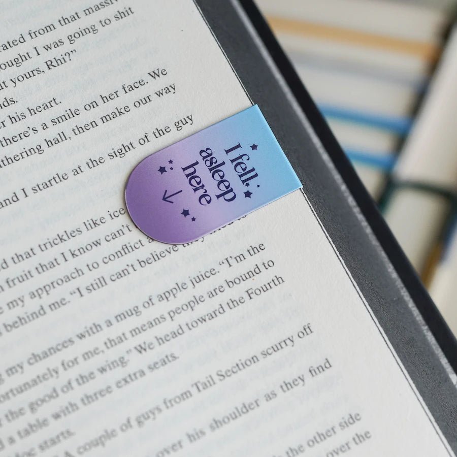 I Fell Asleep Here Magnet Bookmark w/ a blue to purple ombre background, stars, &amp; an arrow pointing down to the book&#39;s page.