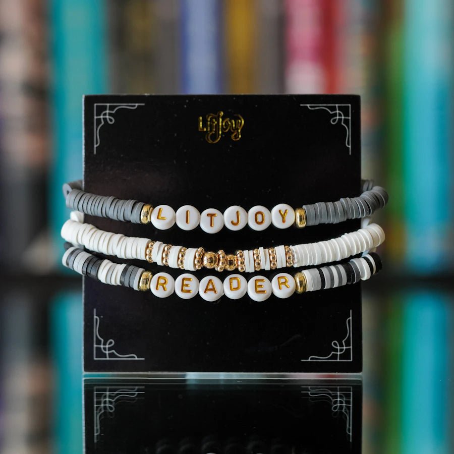 LitJoy Friendship Bracelet Free Gift with Purchase includes three beaded strands in gray and white—says "LitJoy" and 'Reader"