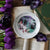 Spring Readers Dessert Plate with an illustration of a lady savoring a book at a sidewalk cafe amidst blooming wisteria