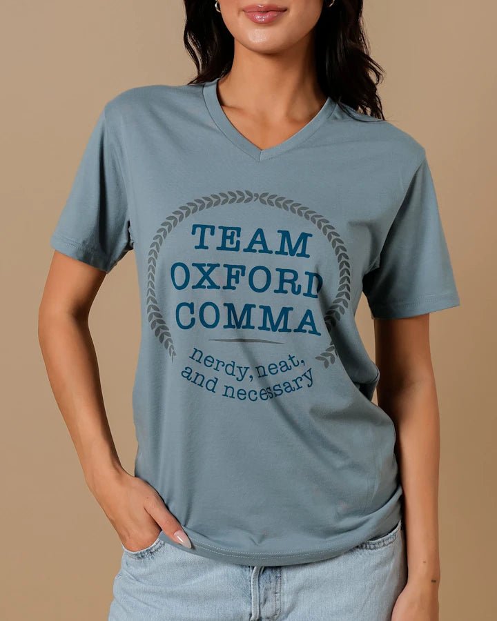 Team Oxford Comma Shirt is a dusty blue v-neck shirt that reads: &quot;Team Oxford Comma | nerdy, neat, and necessary&quot;