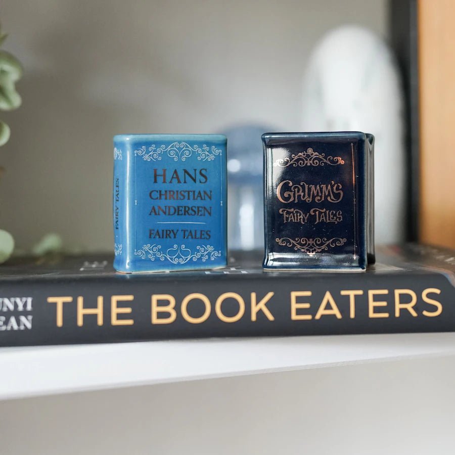 The Book Eaters Salt and Pepper Shakers shaped like fairytale books—Grimm&#39;s (dark blue), Hans Christian Andersen (light blue)