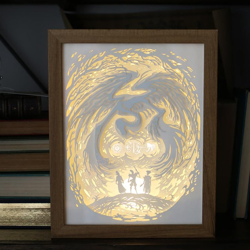 Brothers Light Box is a framed paper cut design of a monster/death above three brothers. Light shines through the paper layers