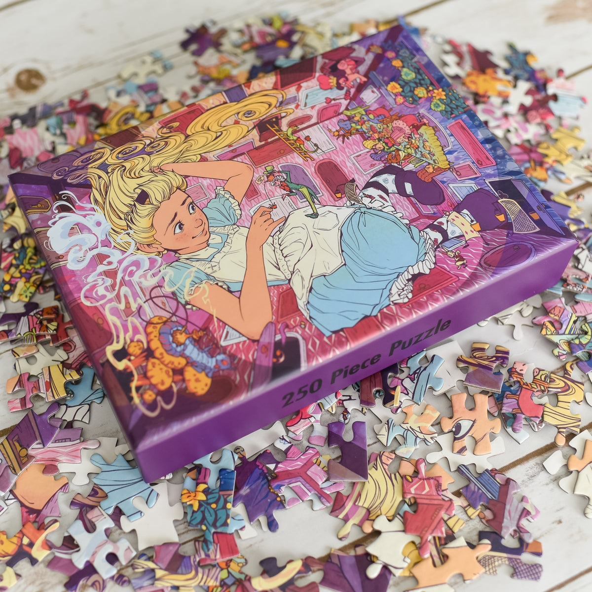 Wonderland Puzzle includes Alice in a blue dress hunched over as details from the books close in on her.
