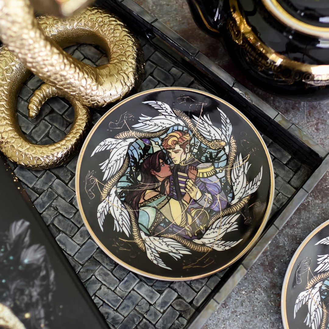 Serpent and Dove Dessert Plate with Lou and Reid includes golden snakes, silver doves on a black plate with gold edge.