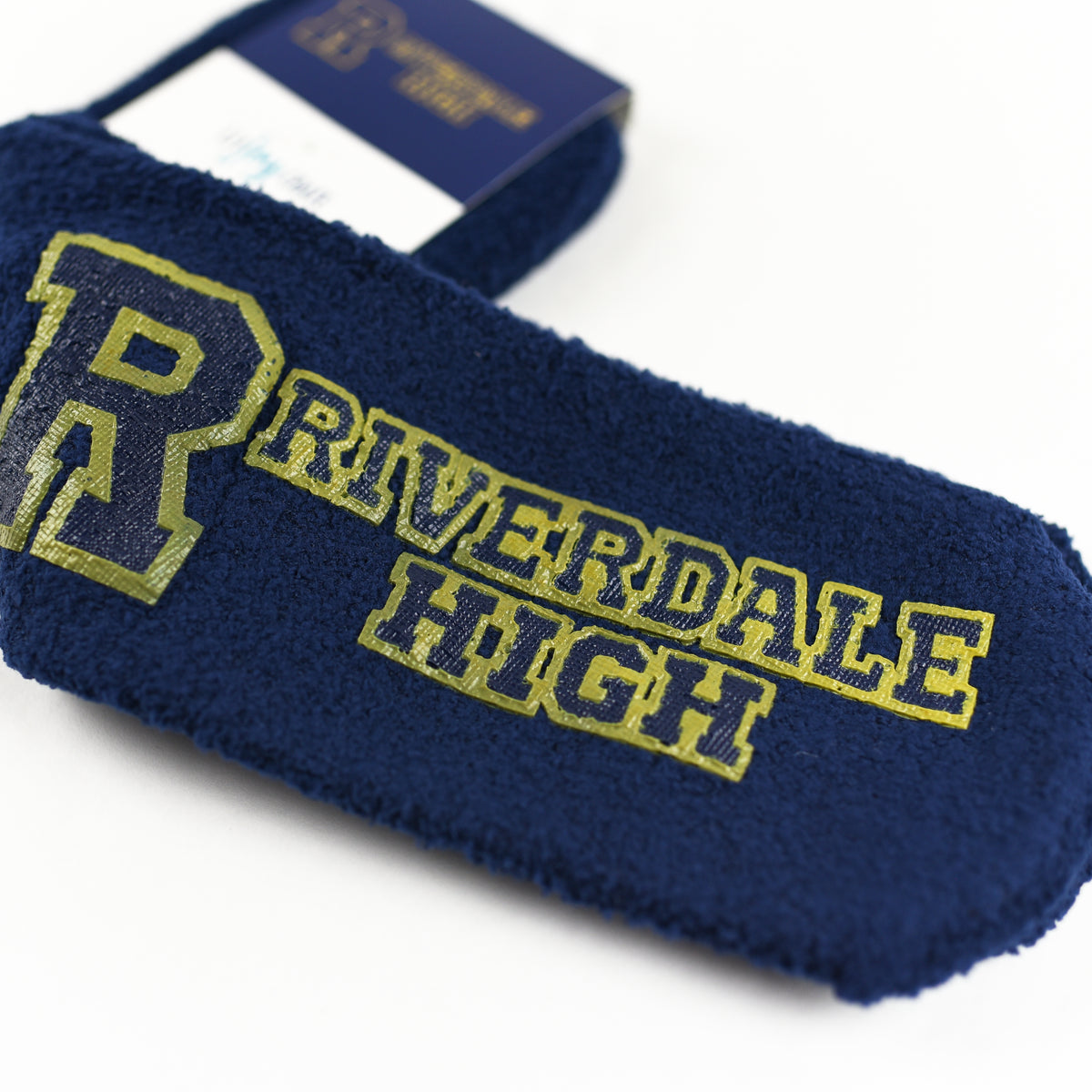 Riverdale Fuzzy Socks are dark blue with gold writing on the bottom of &quot;Riverdale High&quot;