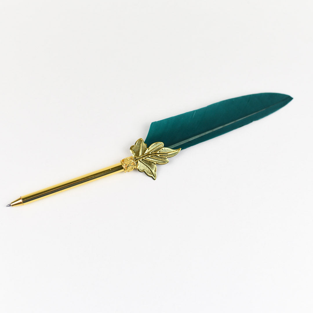 Three Feather Quill Pens in 3 different colors: black, maroon/hot pink, and teal with a gold tip with leaves base