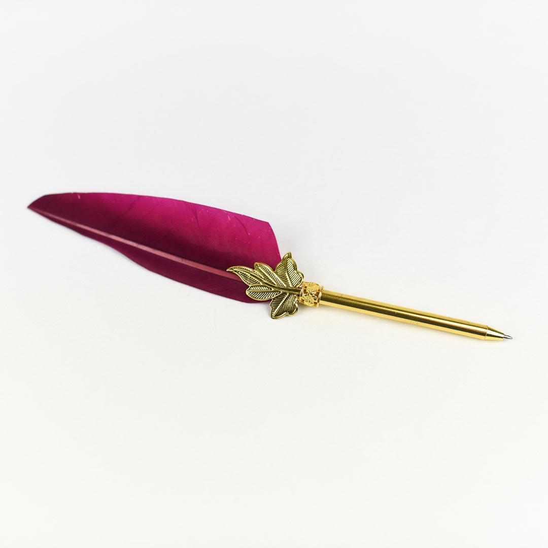 Three Feather Quill Pens in 3 different colors: black, maroon/hot pink, and teal with a gold tip with leaves base