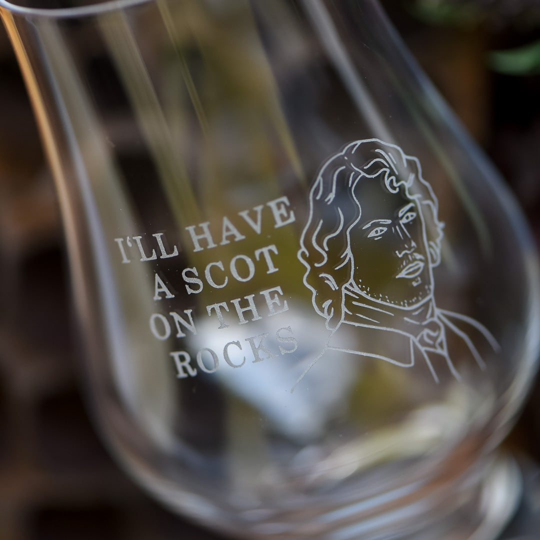 Scot Whiskey Glass is clear with a bell shape and has the words &quot;I&#39;ll have a Scot on the rocks&quot; etched on it along with a handsome highlander&#39;s head
