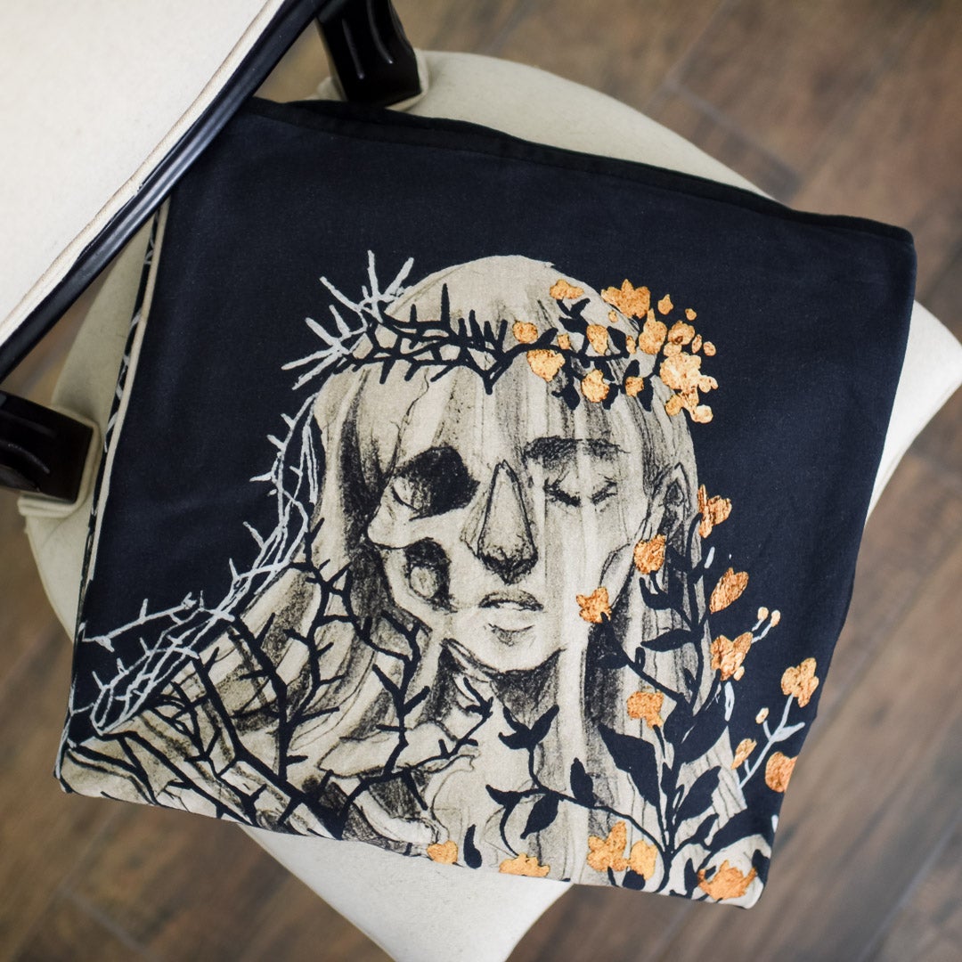 Wuthering Heights Skeleton Blanket is black with Cartherine as a half woman with flowers and a half corpse with dead vines
