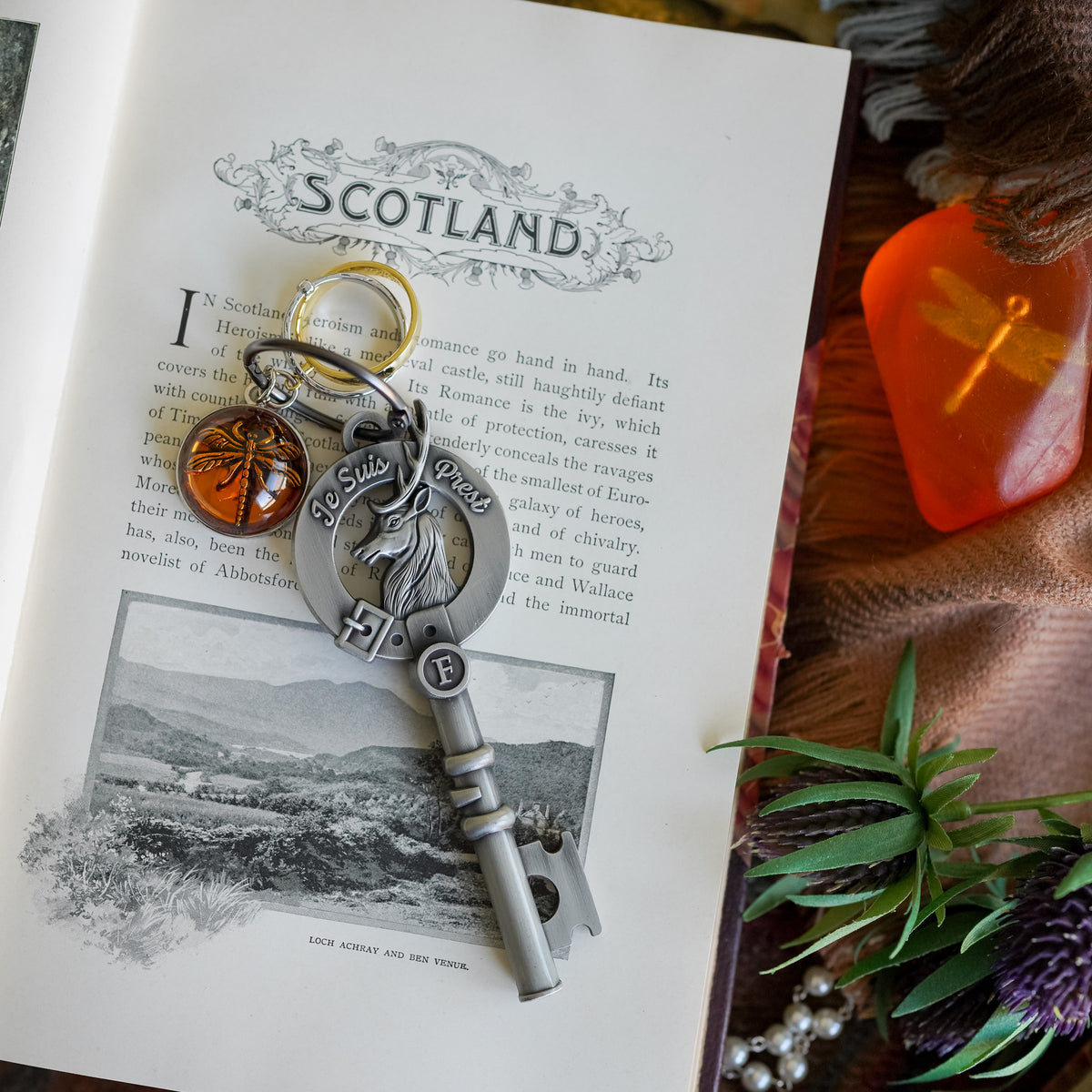 Metal Sassenach Key with the motto &quot;Je Suis Prest&quot;, and wedding ring and dragon-in-amber charms