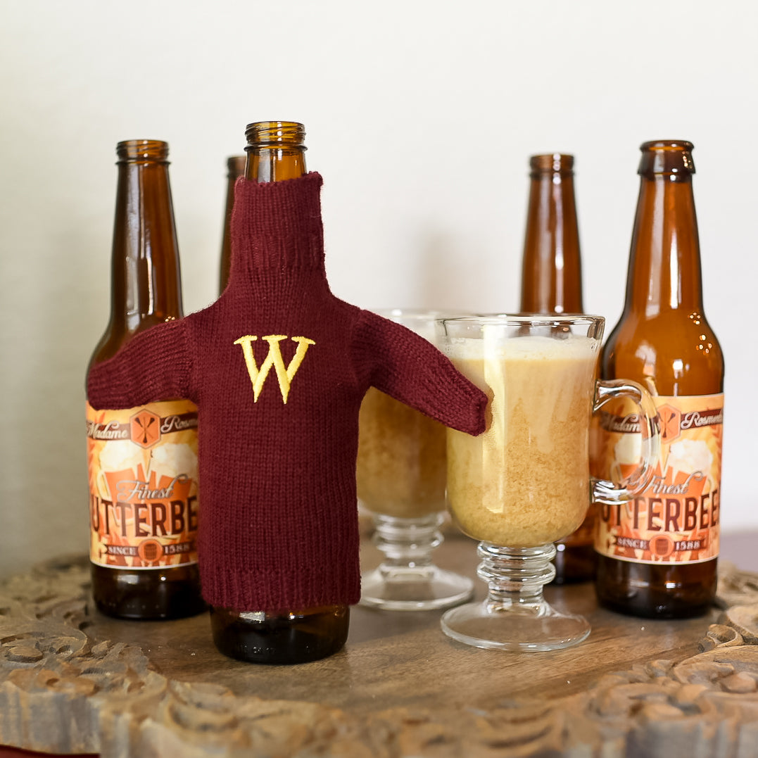 Magical Family Mini Sweater is on a bottle and is maroon with a yellow &quot;W&quot; embroidered on the front