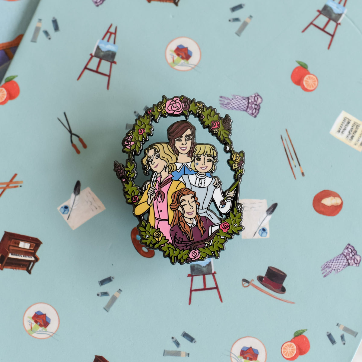 Little Women Enamel Pin includes all the March sisters with a wreath of flowers around them