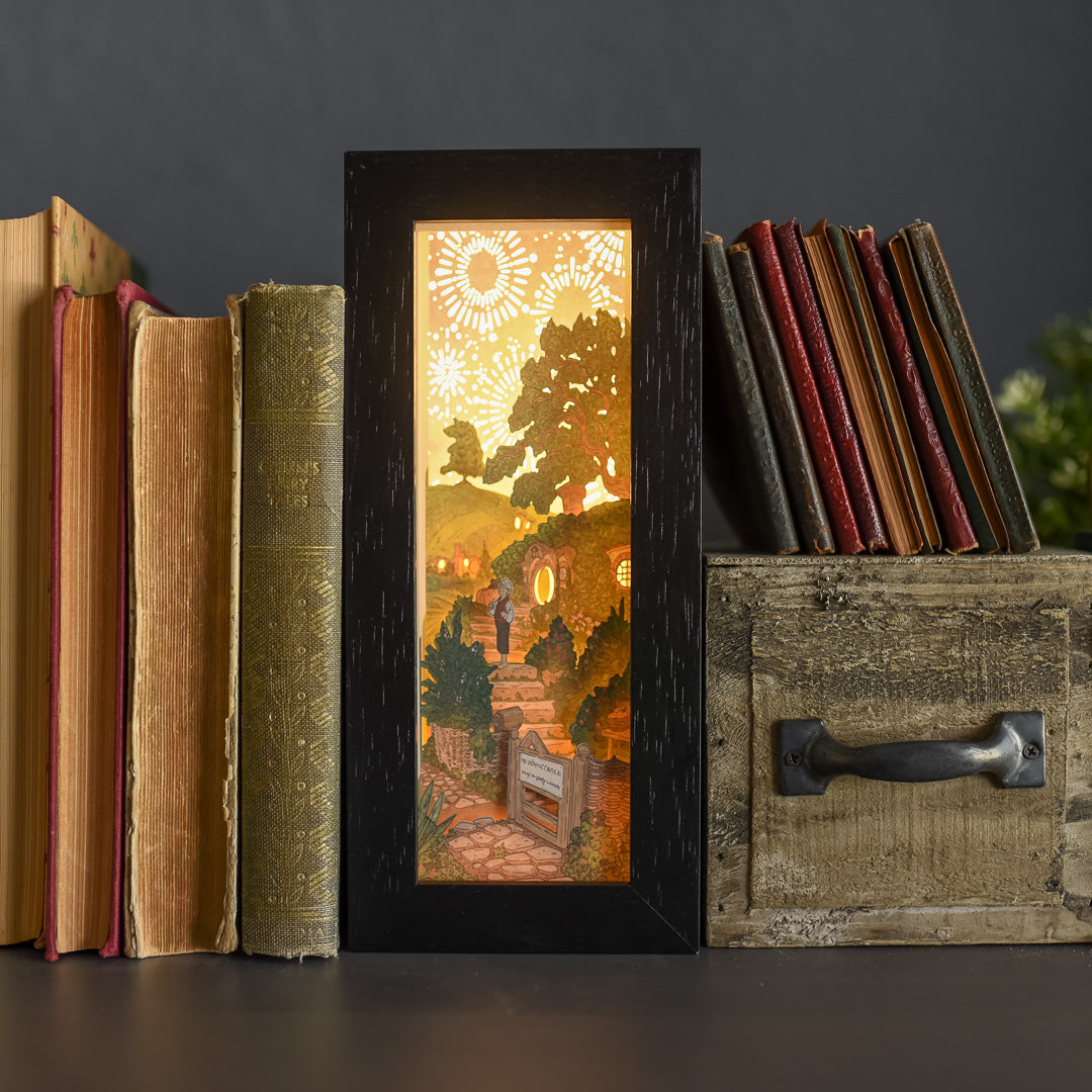 Black frame Halfling Bookshelf Alley with paper art of a hillside home and "No admittance except on party business" sign