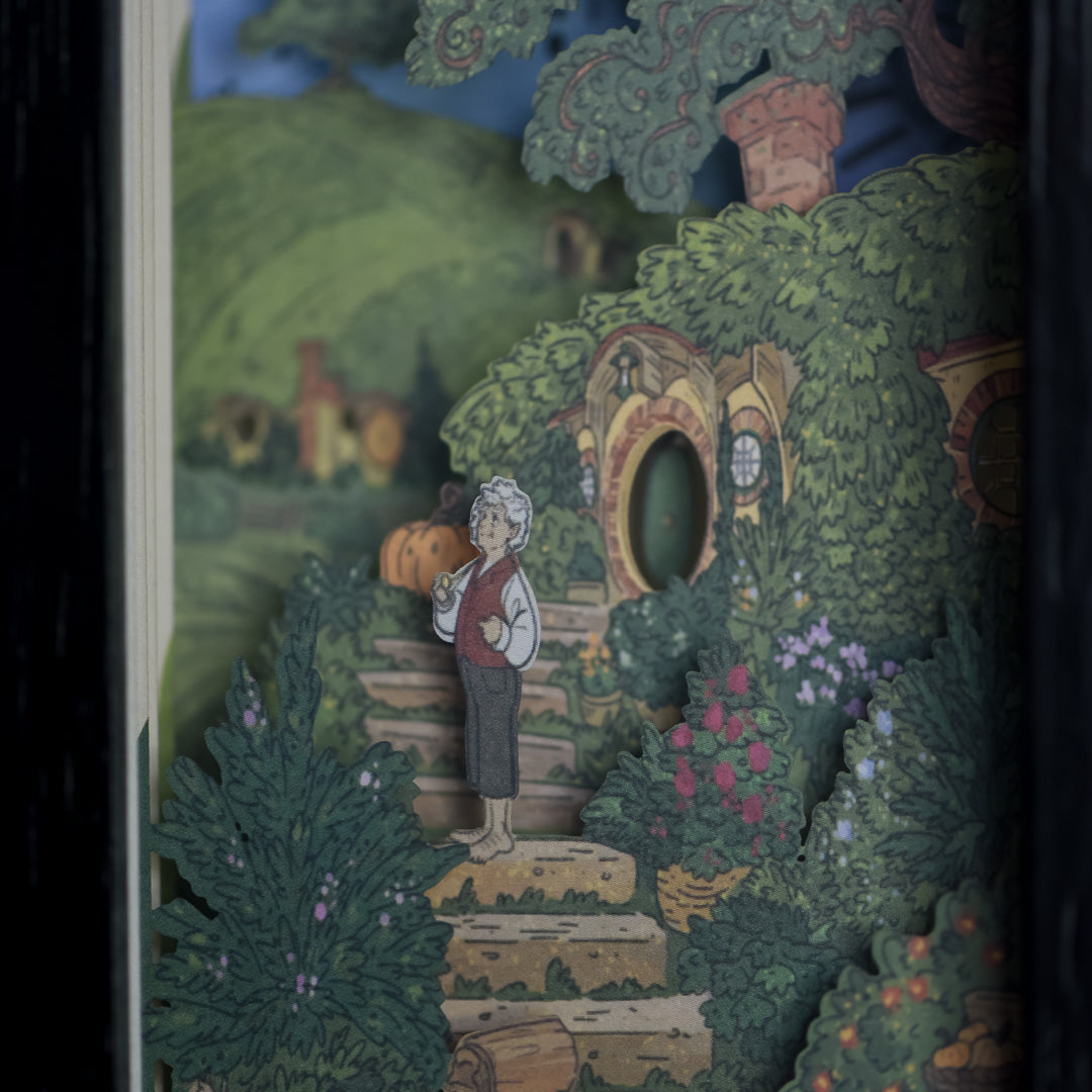 Close up of Halfling Bookshelf Alley with paper art of a halfling at his hillside home 