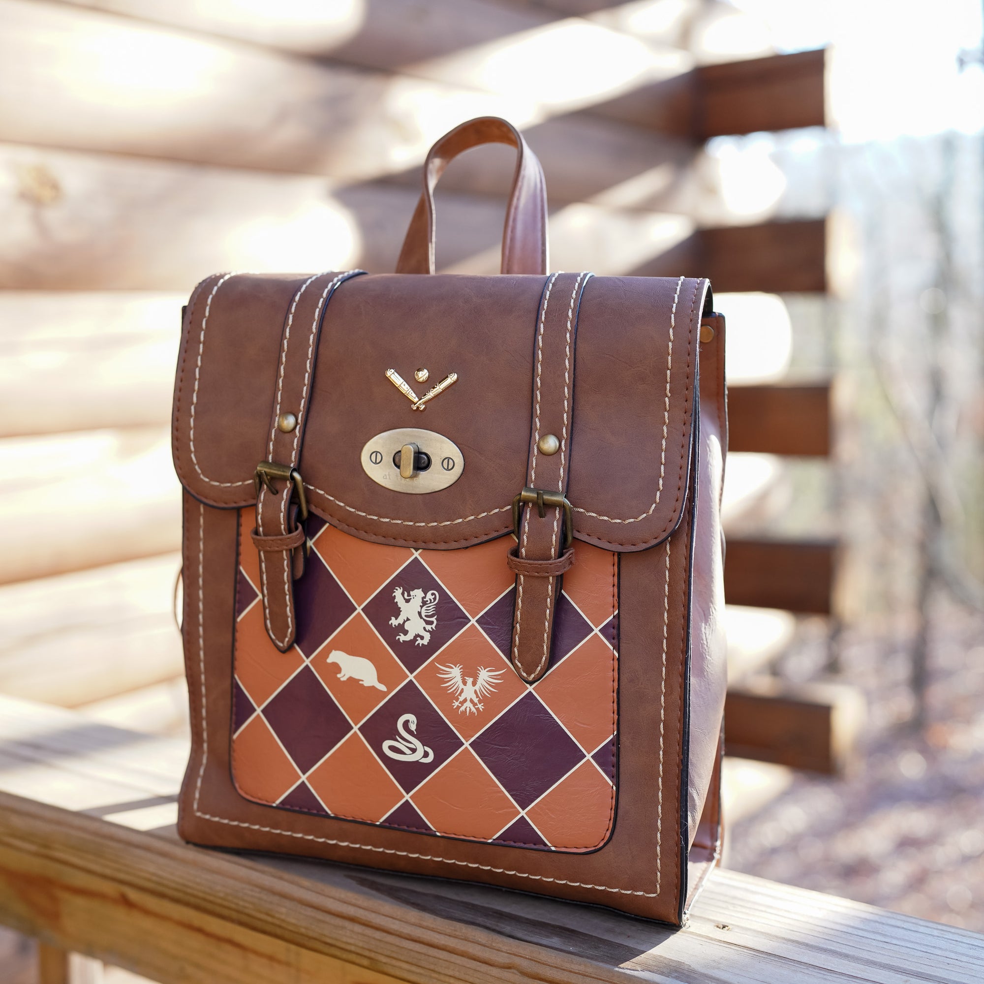 Magical Sports Backpack is made of brown leather, orange and maroon checkers and gold details