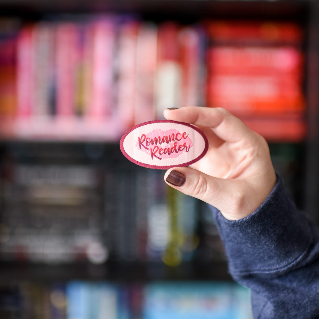 Romance Reader Patch is red and pink with a lipstick kiss in the background and the words &quot;Romance Reader&quot;