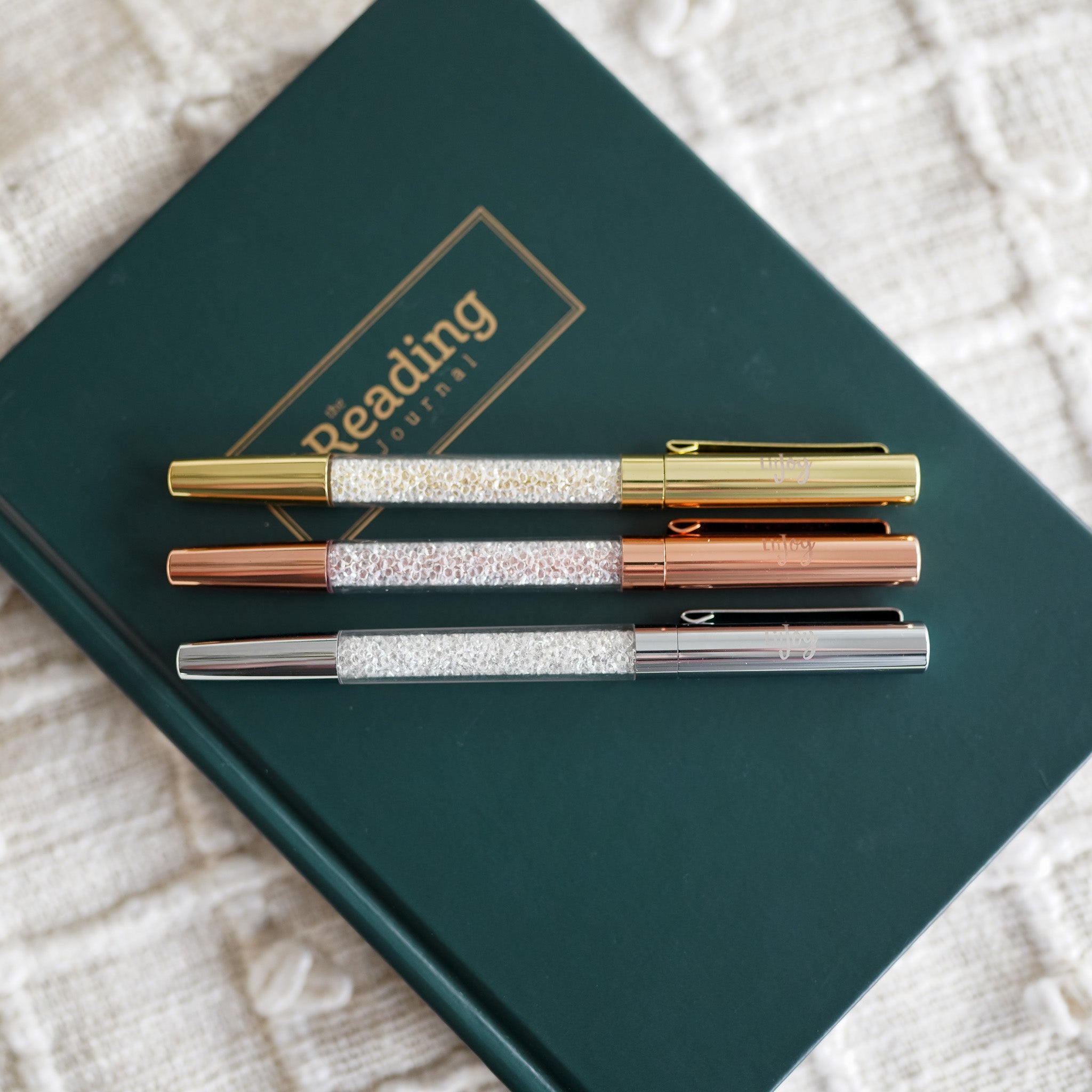 Crystal Pen with metallic details in gold, rose gold, and silver and LitJoy logo on the cap