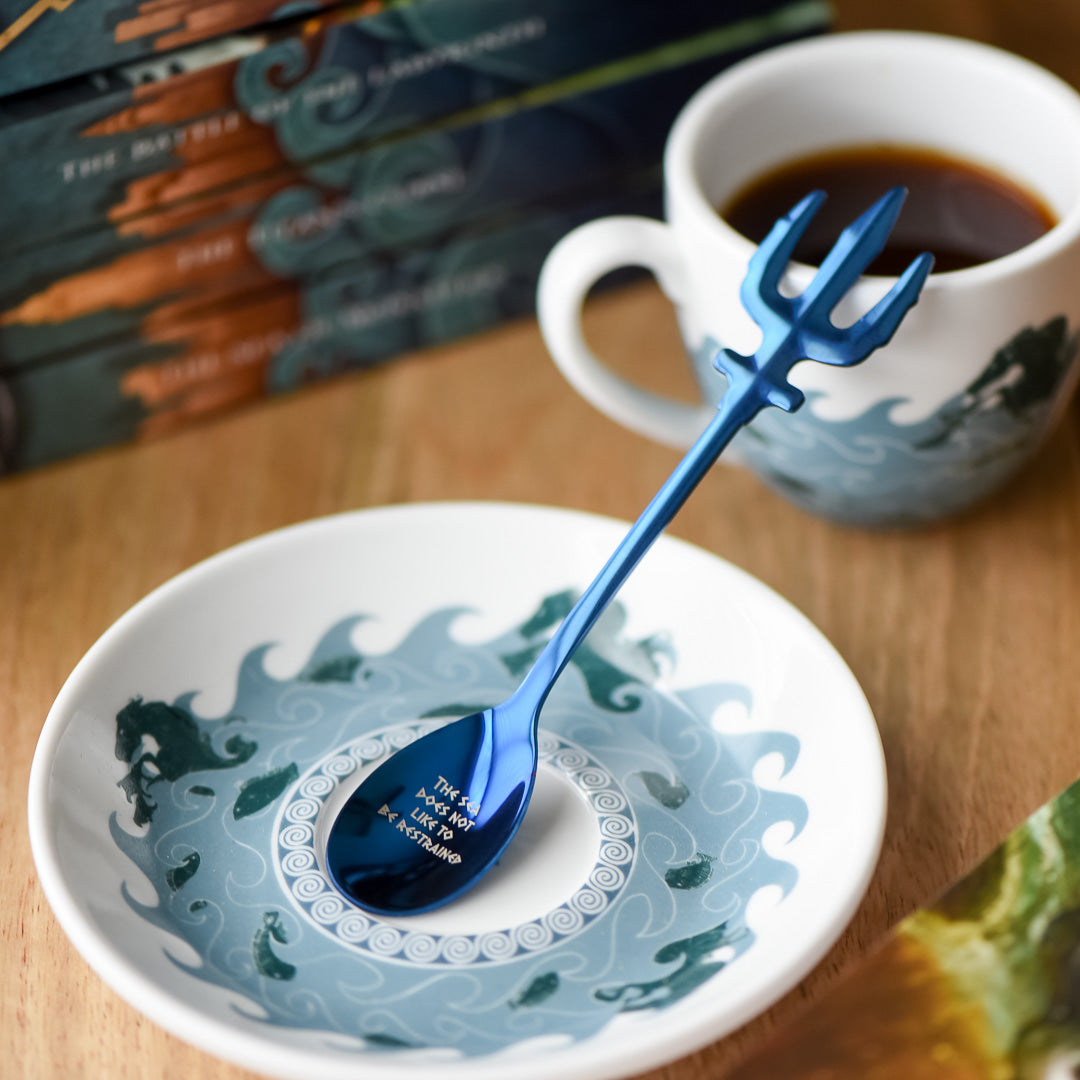 Metallic blue Demigod Teaspoon with a trident handle and the phrase &quot;The sea does not like to be restrained&quot;
