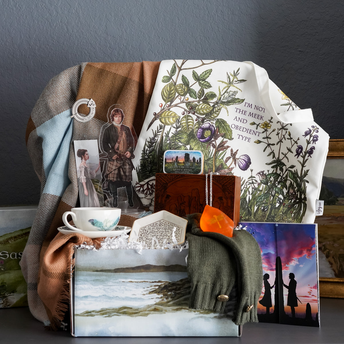Sassenach Crate comes with a teacup, bookmark, trinket dish, loose leaf tea, music box, wedding ring, dragonfly soap, and more