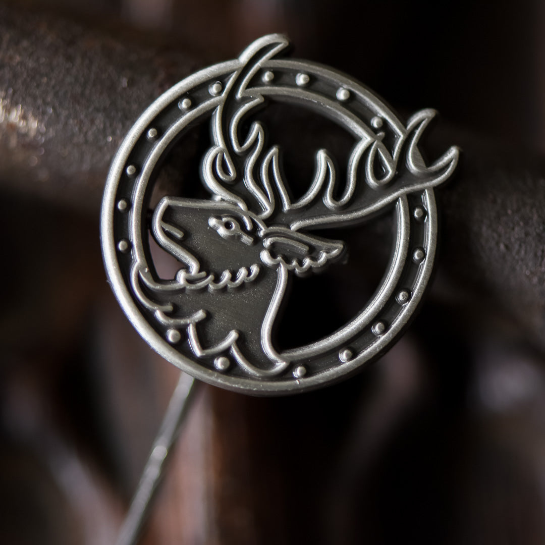 Stag Head Shawl Pin is made of silver metal and has a circular background and a stag with antlers