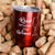 Red Read Between the Wines Tumbler with a lid sitting on a pile of corks