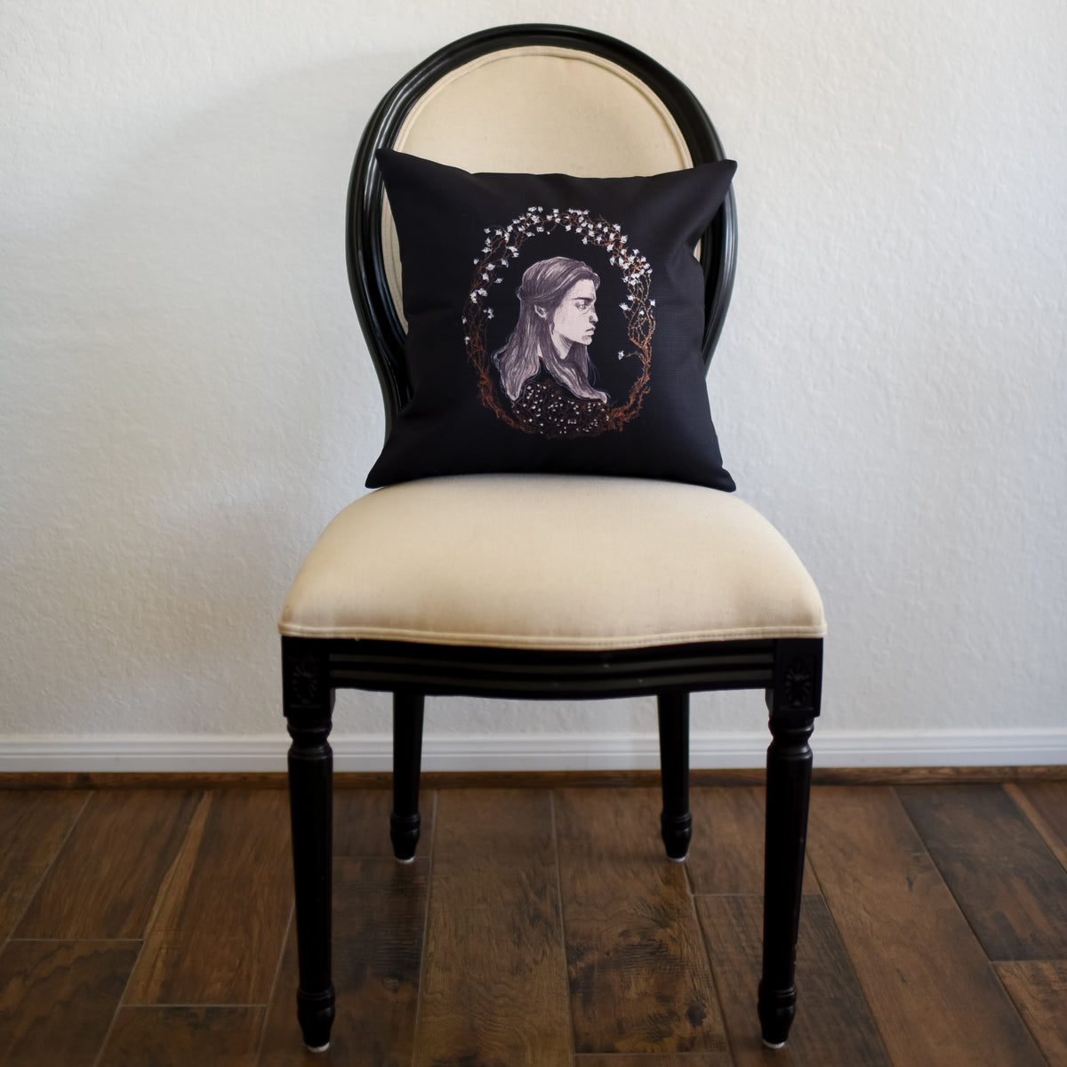 Wuthering Heights Pillow Cover has a cameo of Catherine in black and white with a wreath of branches and flowers around her head