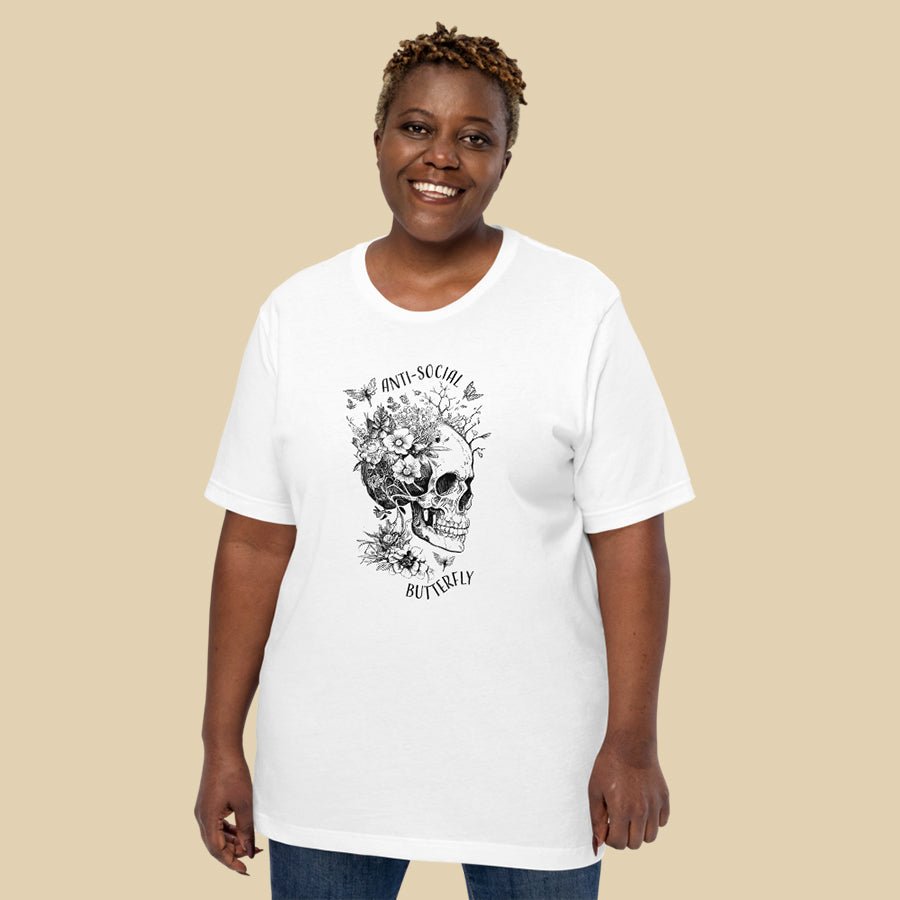 Anti-Social Butterfly Shirt is a t-shirt for book lovers that comes in multiple colors and has a skull growing with flowers, butterflies, and fairies.